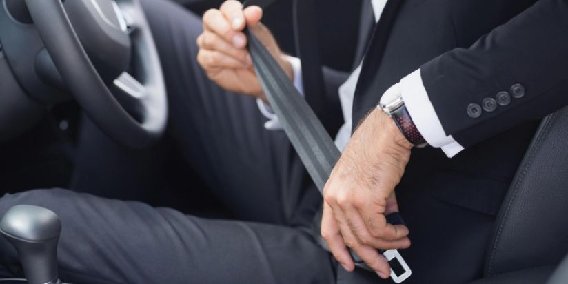 A man putting of the seat belt of a limo