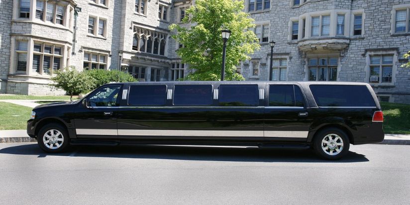 The standard stretch limo is parked to a lovely house