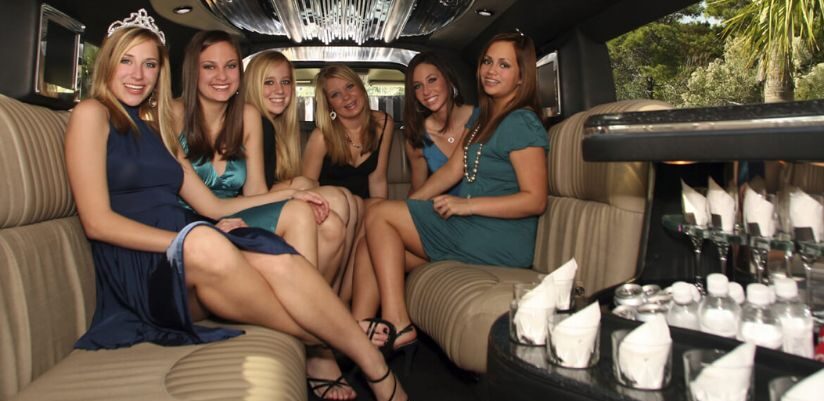 six prom girls are sitting in a limousine